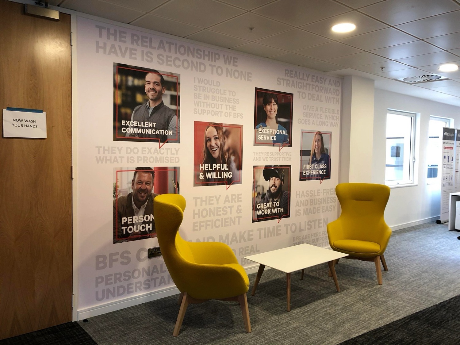 Printed interior wall mural of customer testimonials in an office reception