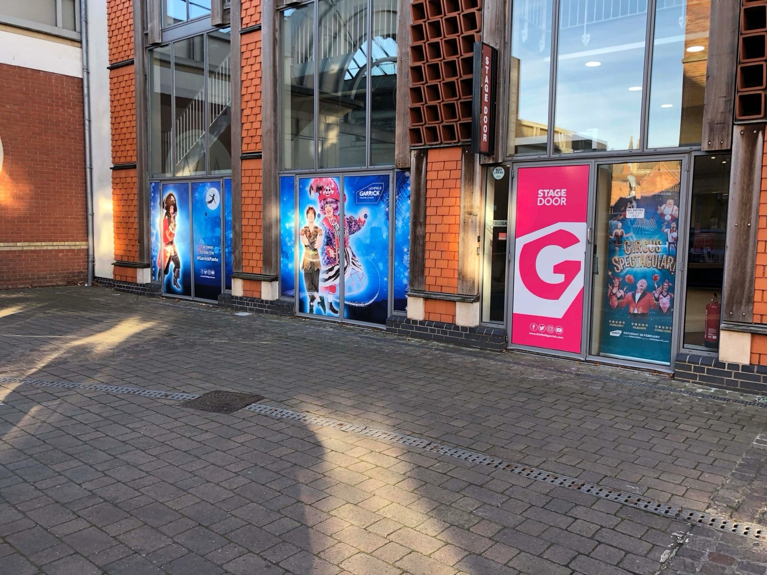 Large window graphics and theatre posters at the Lichfield Garrick stage door